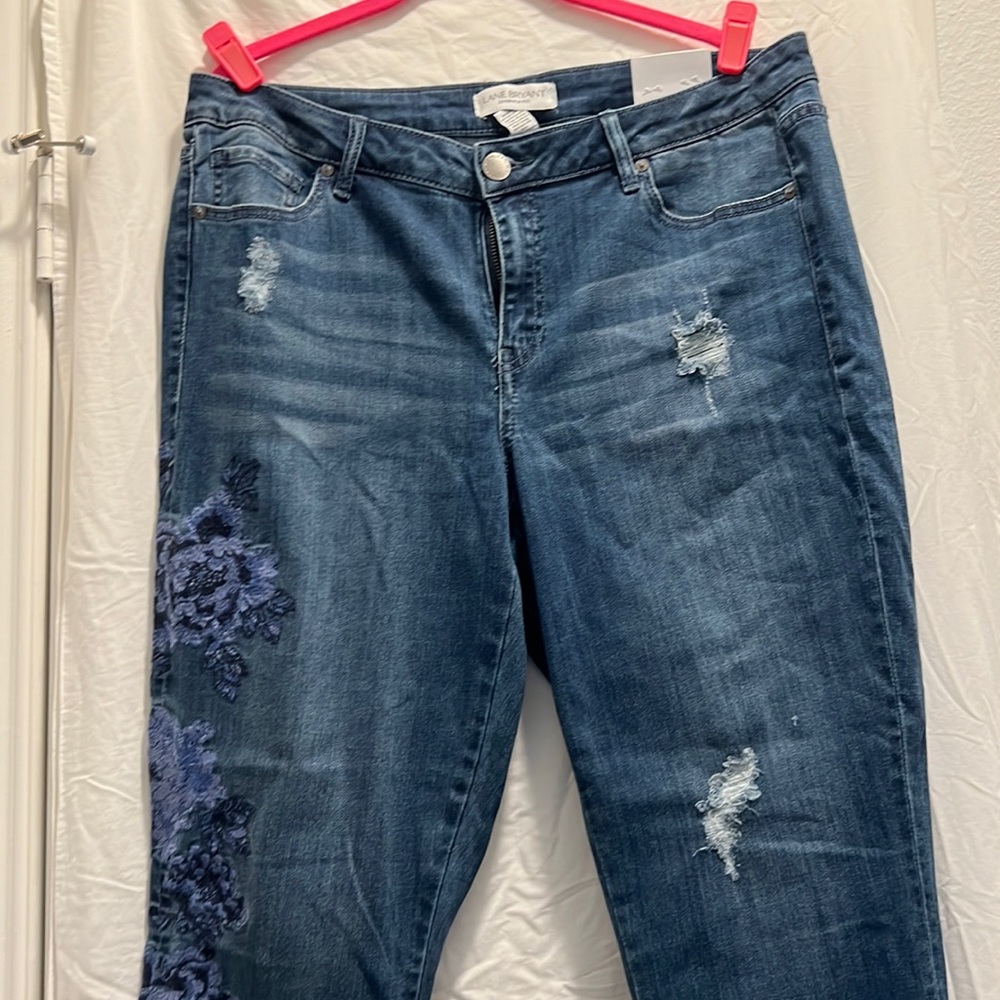 Denim jeans with rips on bottoms flowers on right side Lane Bryant